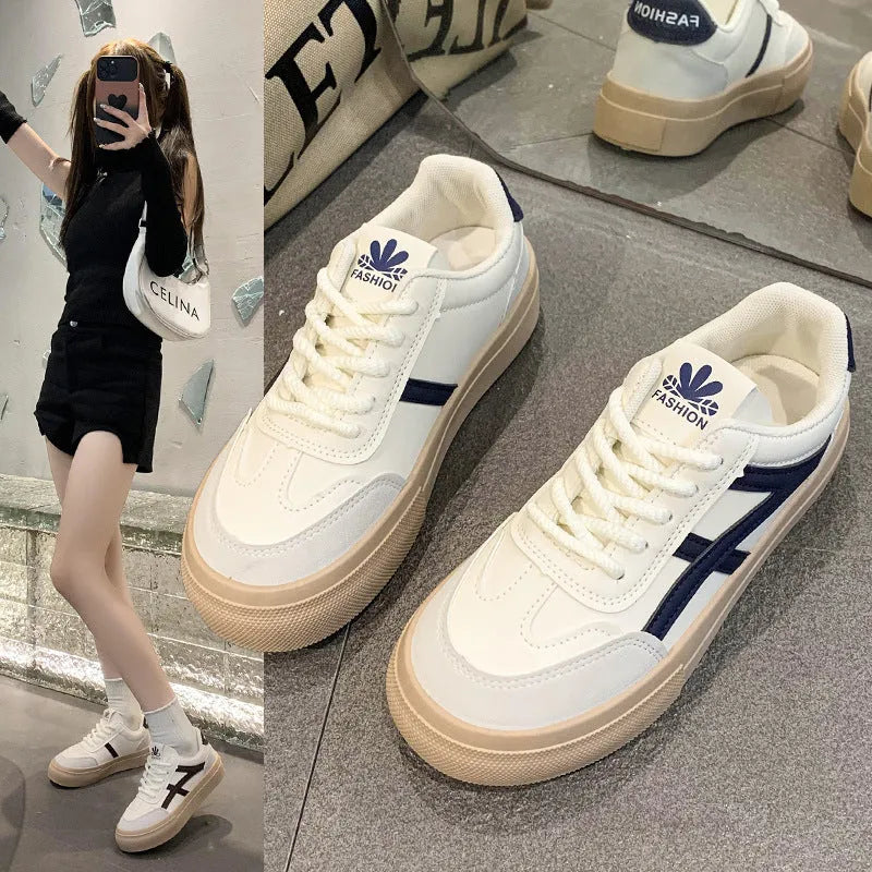 Blue low-top women's casual trainers with round toe and white rubber sole on a plain background.