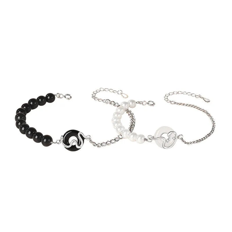 Close-up of a 925 sterling silver bracelet with a safe buckle, featuring obsidian pearls and a detailed snake charm in a new Chinese style.