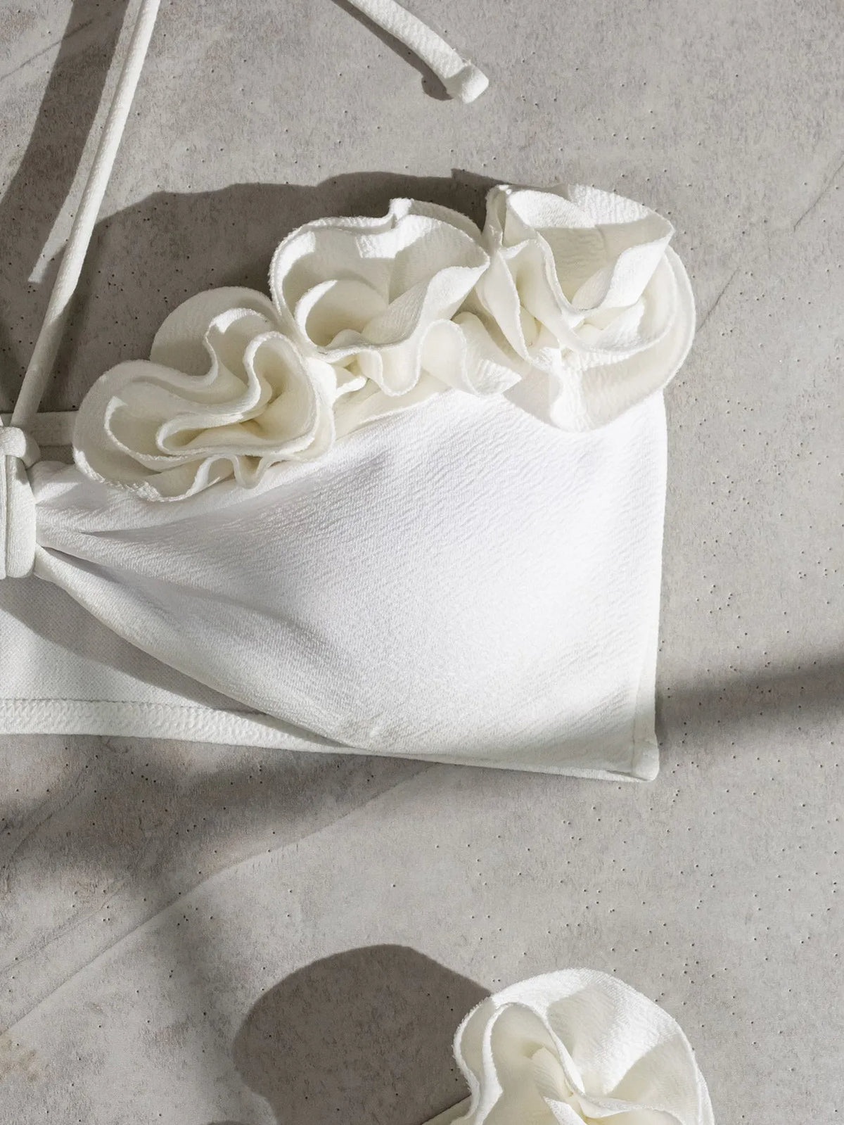 White split swimsuit with three-dimensional flower, halter lace-up neck, and briefs style, sizes S M L