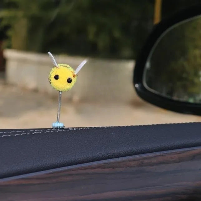 Small yellow and black fur ball bee car decoration ornament measuring 3cm.