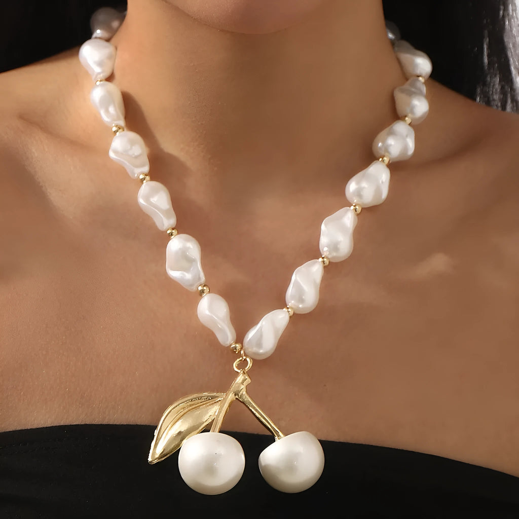 Gold and white K electroplated alloy necklace with irregular cherry fruit pendant and imitation pearls, adjustable chain.