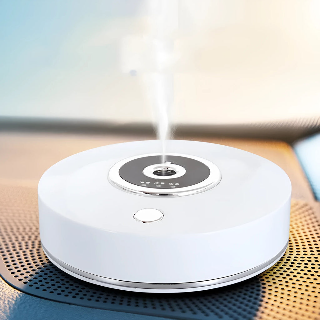 White plastic USB-powered car fragrance spray holder attached to a vehicle air vent.