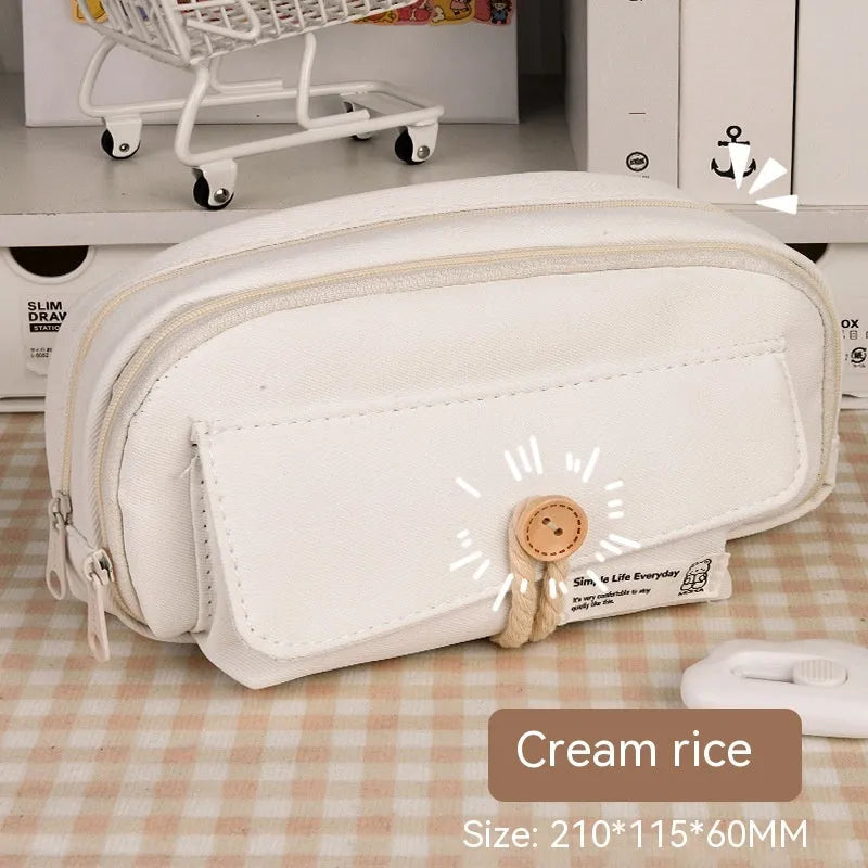 Girls canvas pencil case with button fastening showing large capacity for approximately 80 pens in beige colour