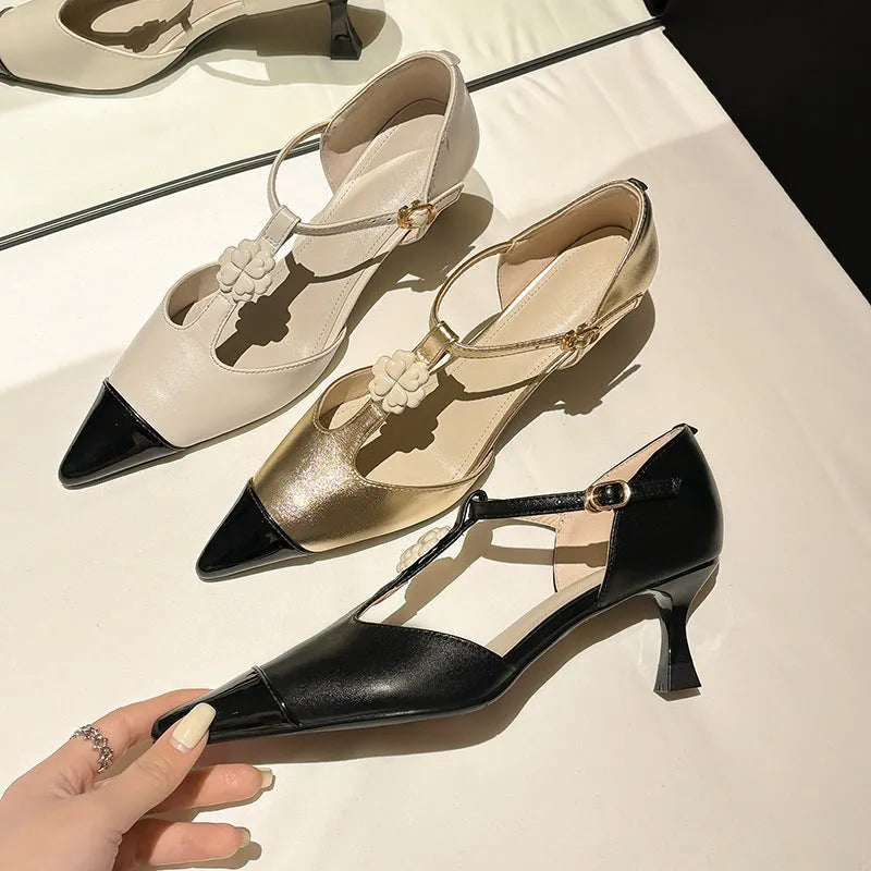 Women's gold stiletto shoe with flower decoration and buckle on a pointed toe goat leather upper.
