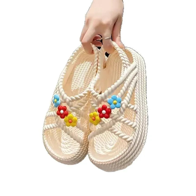 Beige PVC sandals with a round toe, non-slip sole, and a sunflower decoration.