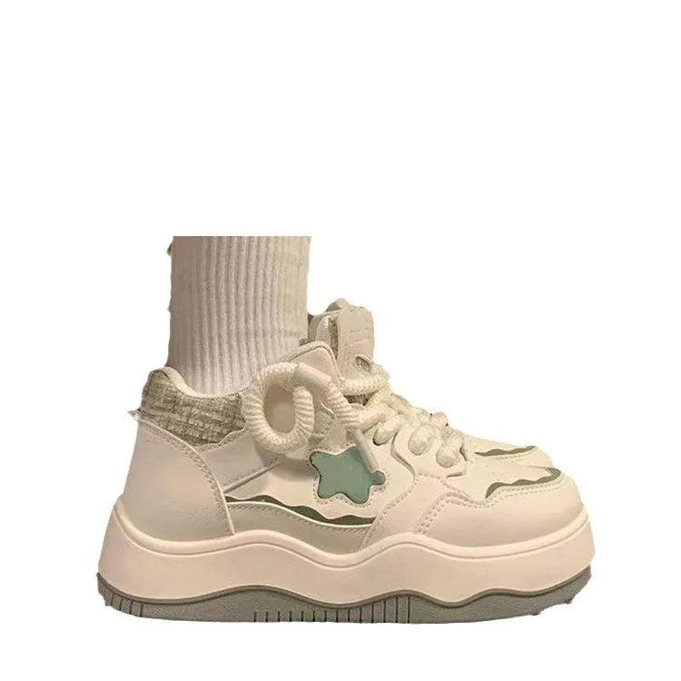 Women's green patent leather platform sneakers with round toe and white laces