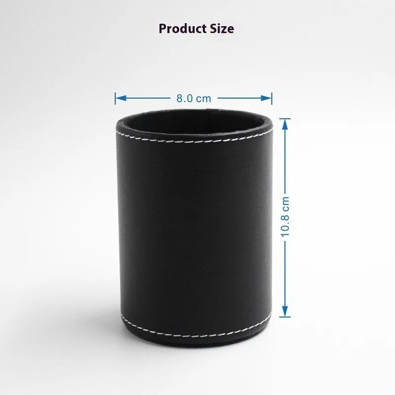 Small round black leather pen container on a desk