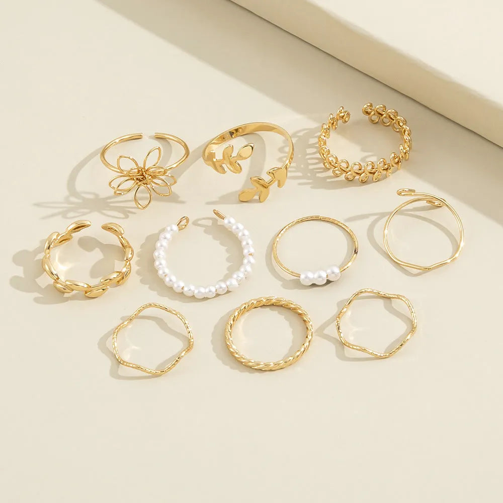 Gold coloured openwork floral design alloy ring set for women, showing glossy electroplated finish.