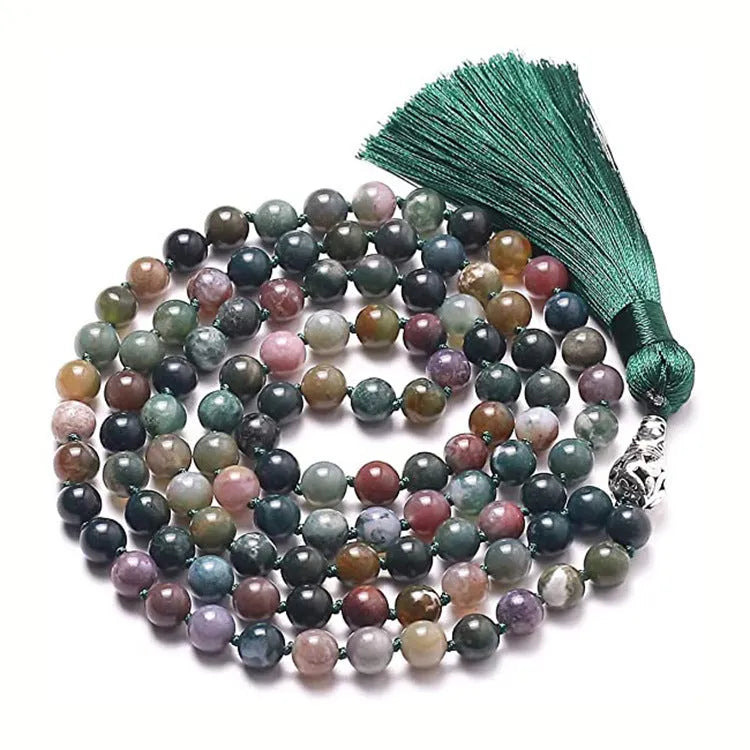 Long agate tassel necklace with geometric beads in multiple natural stone colours on a white background.