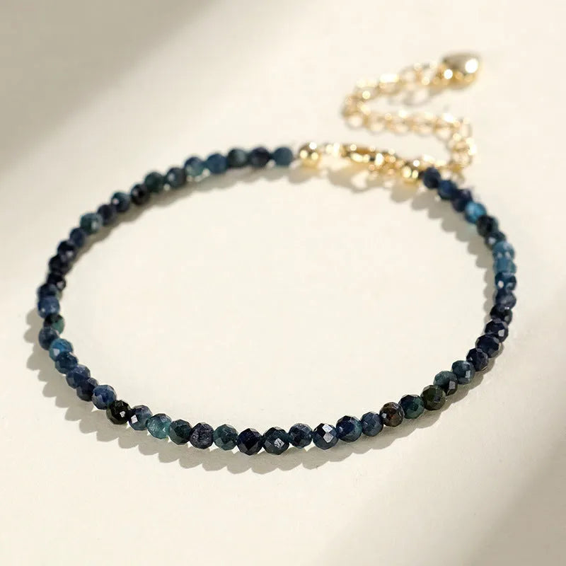 Blue tourmaline 3mm bead bracelet with spacer design on wrist