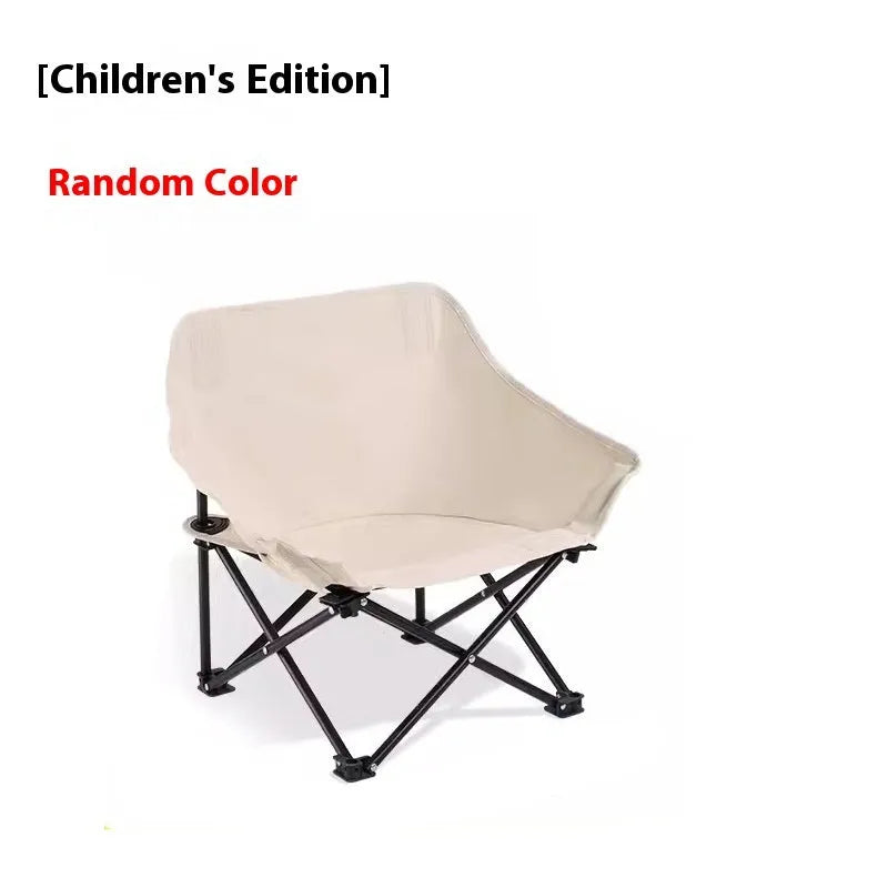 Beige portable folding camping chair with steel frame on grass outdoors