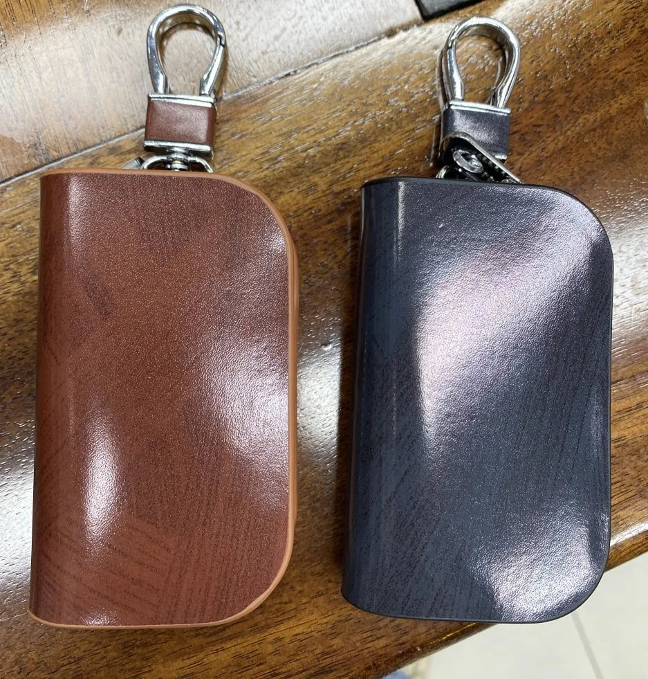 Genuine leather car key case in black or brown with frosted finish and 9.5cm by 4.5cm internal dimensions
