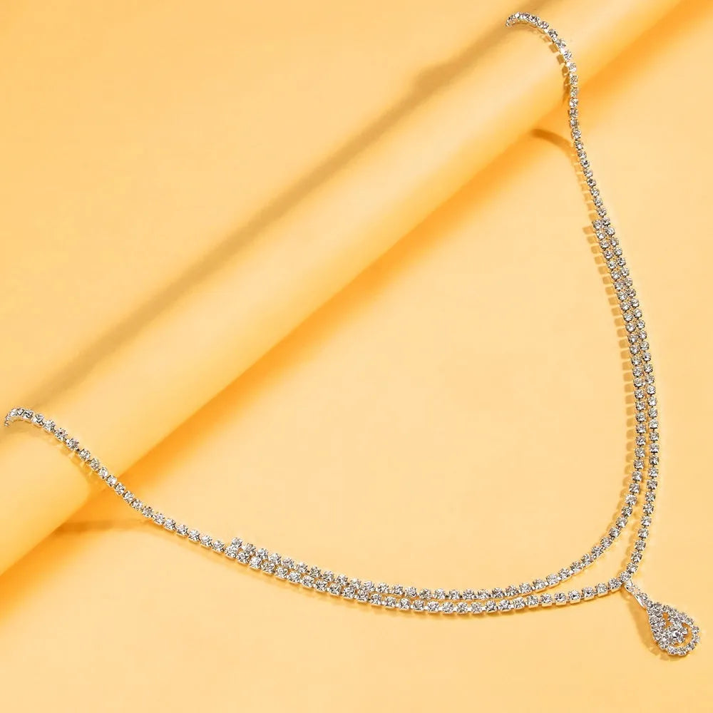 Gold or silver waist chain with water drop pendant and rhinestone accents, lobster buckle clasp