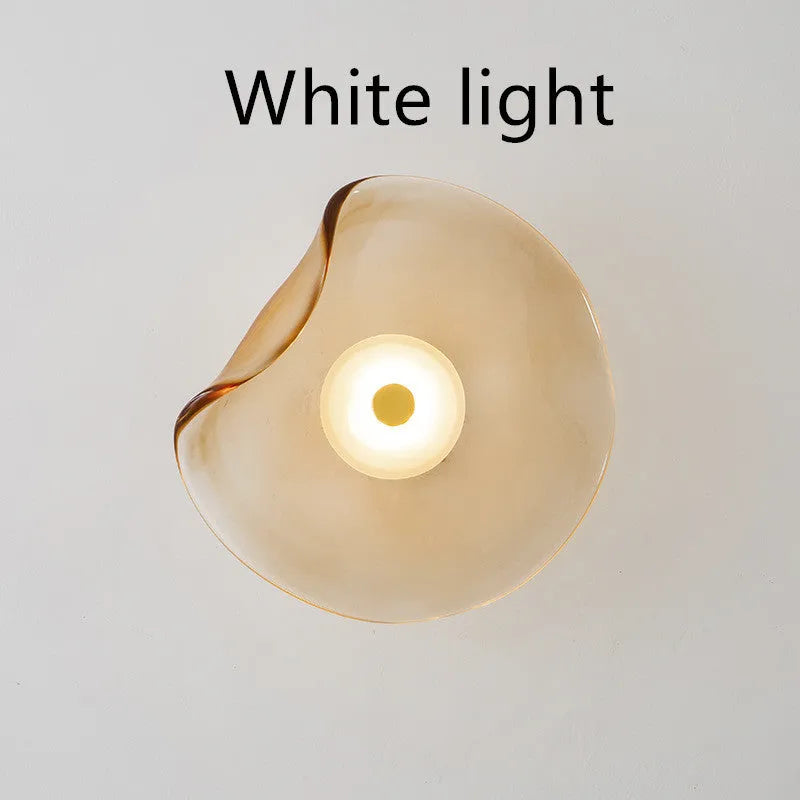 Round decorative wall lamp with glass shade in cognac colour for bedroom bedside lighting
