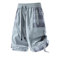 Men's black loose-fit cargo shorts with plaid stitching on the legs