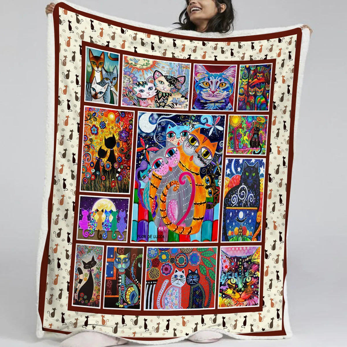 Multicoloured cat themed Sherpa fleece blanket 130x150cm with hemmed edges on a sofa
