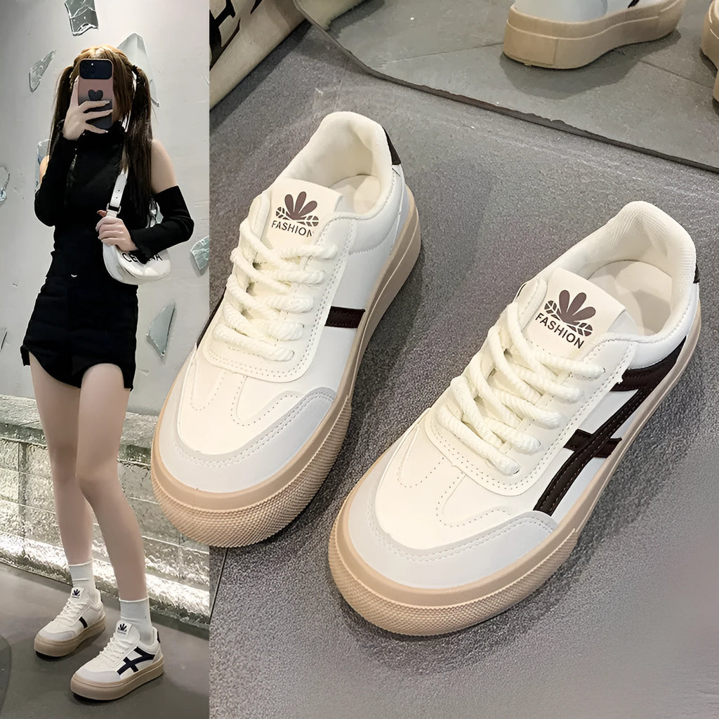 Blue low-top women's casual trainers with round toe and white rubber sole on a plain background.