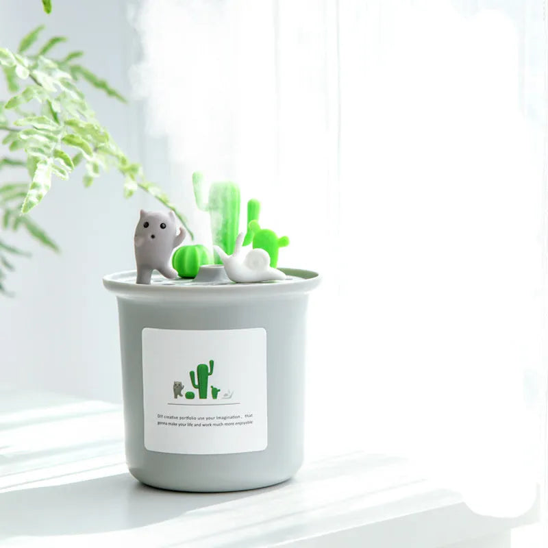 Creative cute pet vase-shaped ultrasonic humidifier in ivory white with USB cable on desk