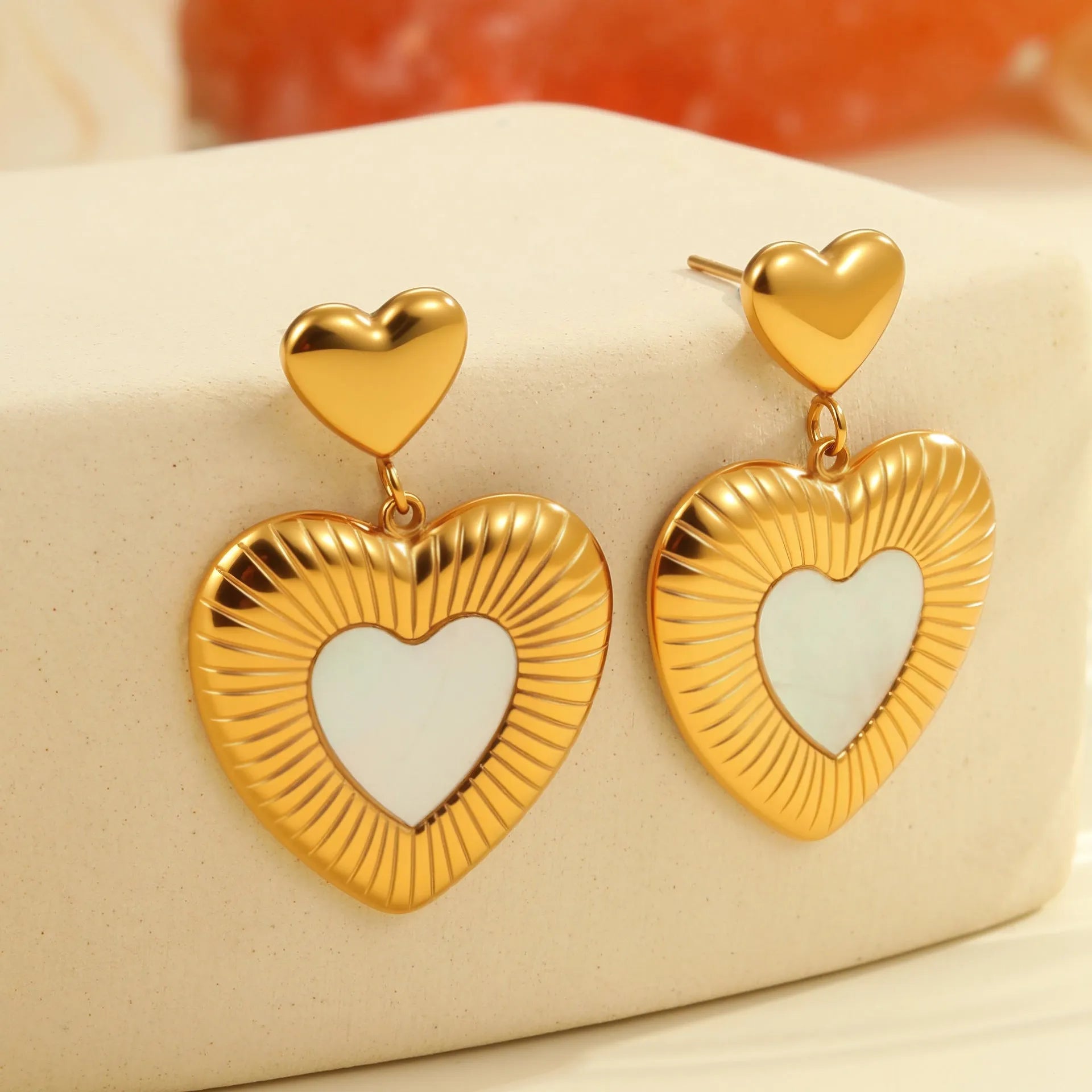 Gold electroplated heart-shaped earrings with fritillary design on stainless steel