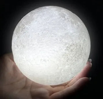 3D printed white moon lamp on a wooden stand with touch-control ring at base