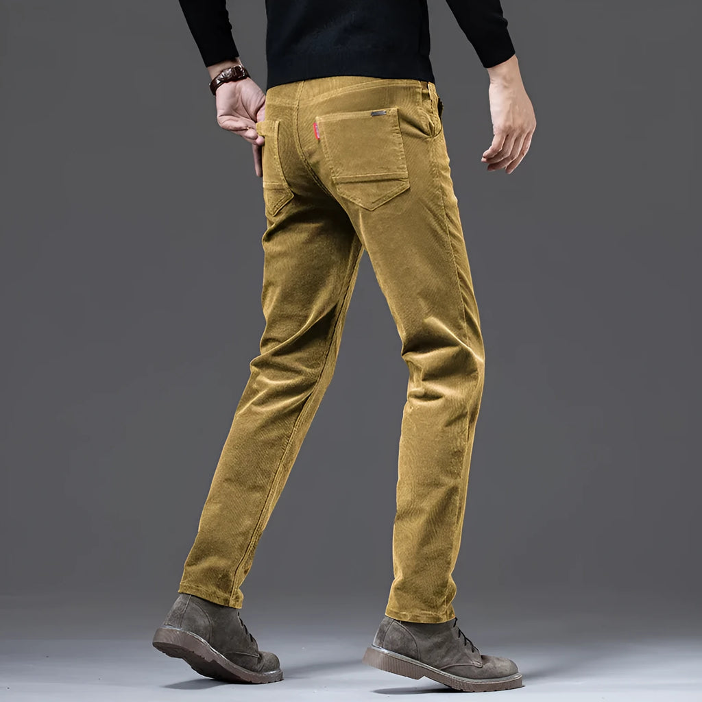 Men's straight slim-fit corduroy trousers in black, cotton fabric, side view on model