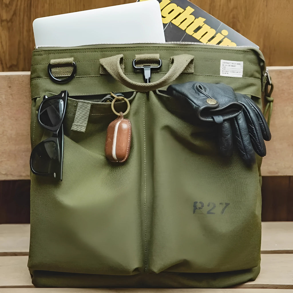 Canvas messenger bag in charcoal black with shoulder strap showing laptop compartment