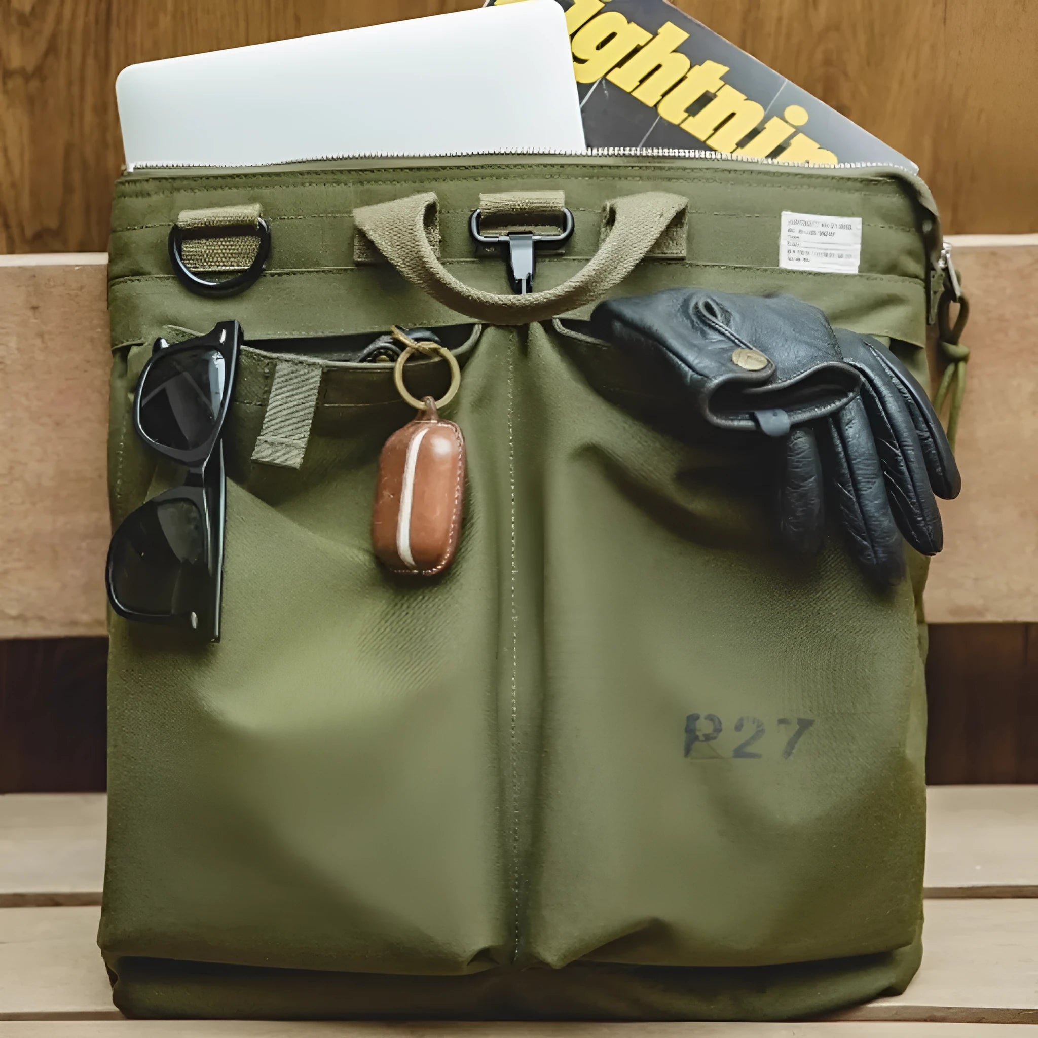 Canvas messenger bag in charcoal black with shoulder strap showing laptop compartment