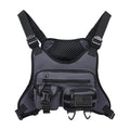 A man wearing a black Oxford cloth chest bag vest with adjustable straps, suitable for riding and outdoor sports.