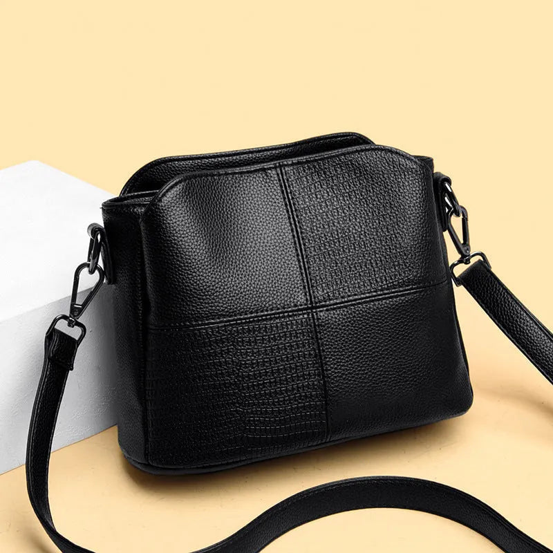 Retro ladies small bucket bag in PU with multilayer zip pockets and double-joint shoulder strap, shown in black, red, or purple.