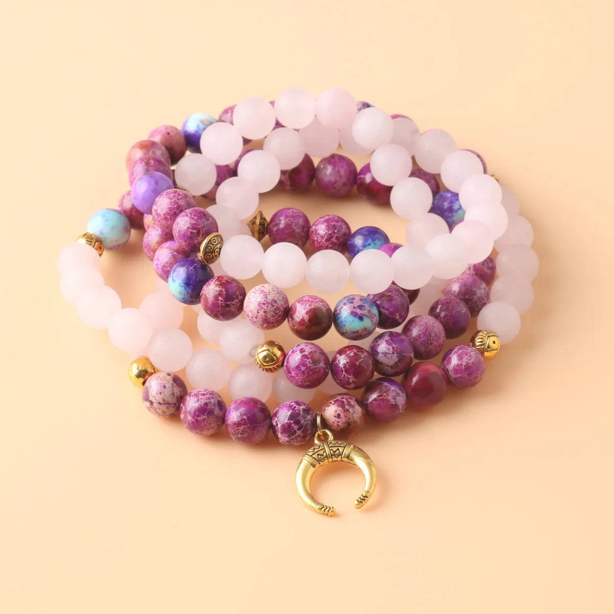 Close-up of a pink emperor stone crystal bead pendant on a necklace chain for casual wear.
