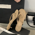 Women's black rubber flip-flop sandals with stiletto heel and round toe on a white background
