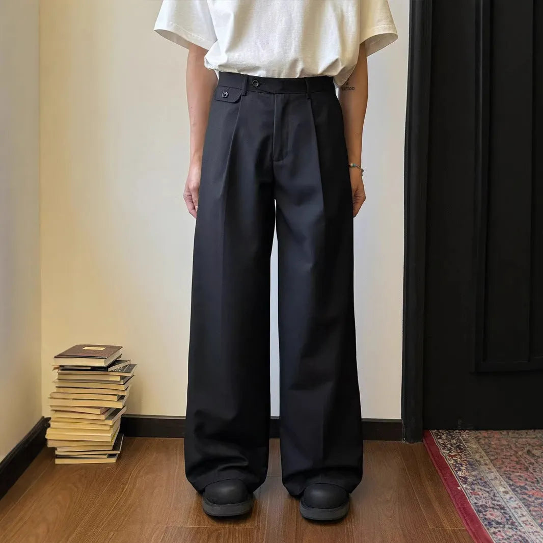 Men's brown straight-leg casual trousers with a loose, wide-leg fit on a neutral background.