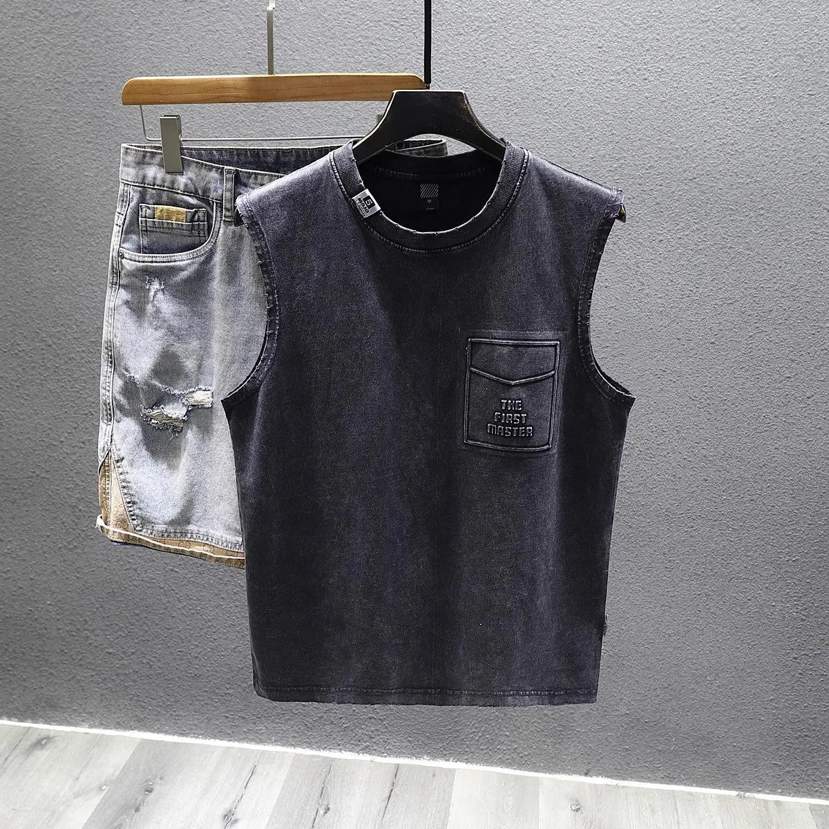 Cotton sleeveless fitness t-shirt in solid black colour showing loose fit and straight hem design