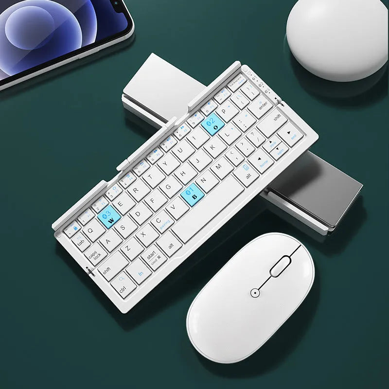 Silver white folding Bluetooth keyboard with stand holding a smartphone, showing compact folded size