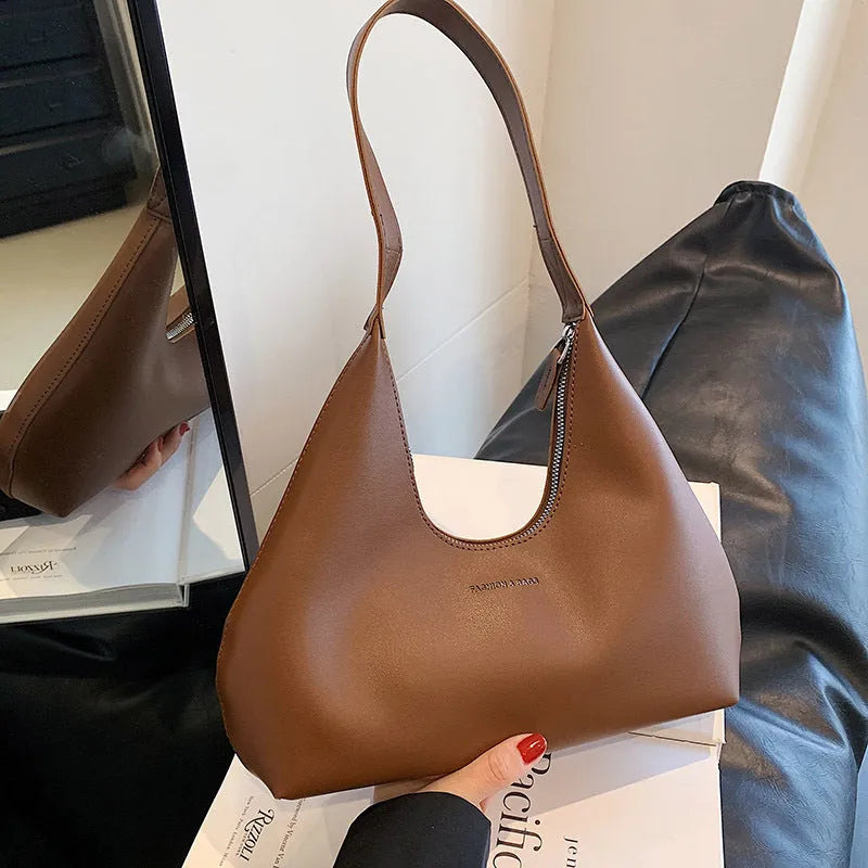 Women's retro style PU shoulder handbag in pillow shape with organised interior compartments