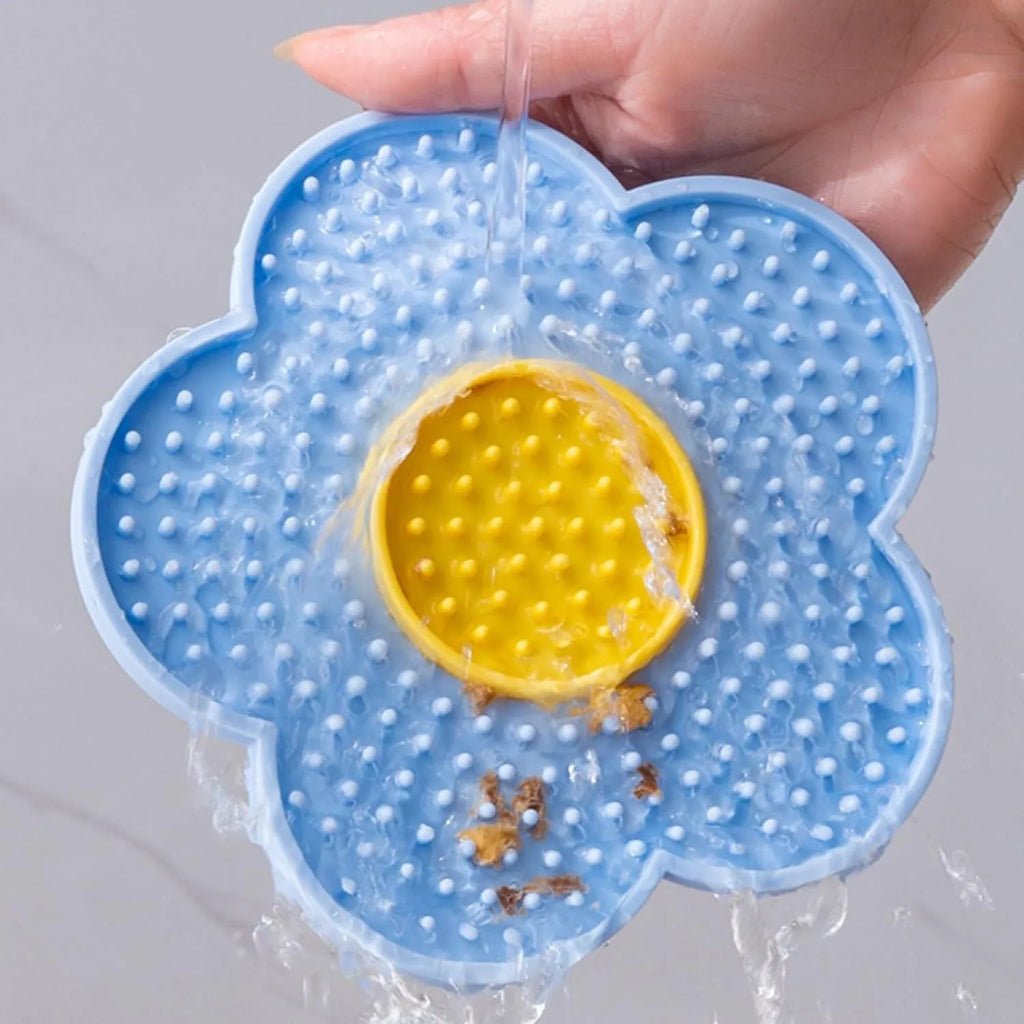 Flower-shaped silicone lick mat for cats and dogs with suction cups on the base, shown in a choice of colours.