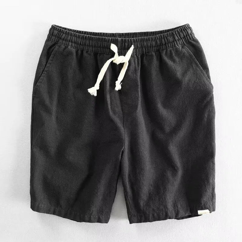 Man wearing loose-fitting cotton and linen casual shorts in a straight-leg style with an elasticated waist.