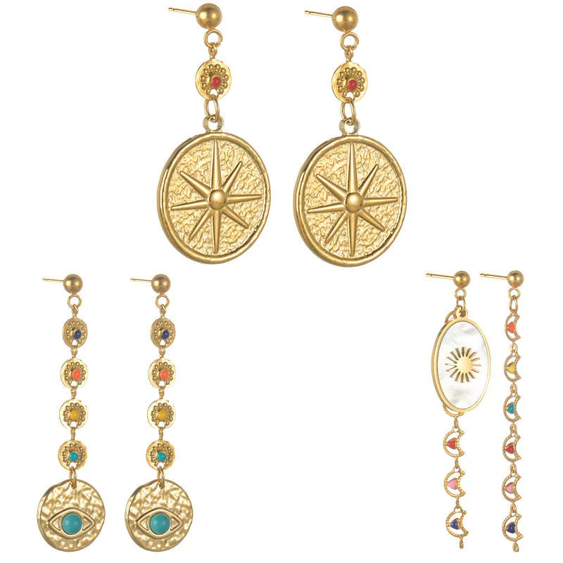 Three pairs of geometric stainless steel earrings showing Eight Awn Star, Eye, and Shell Sun designs