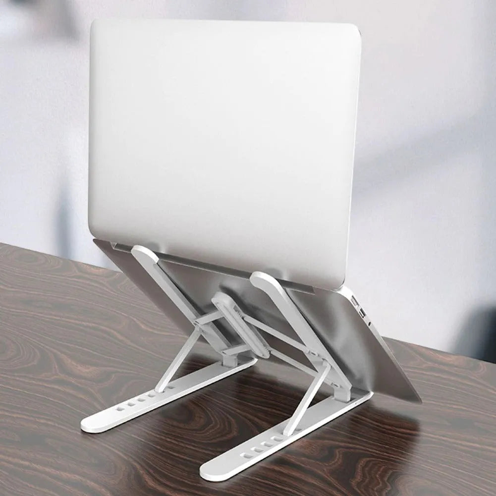 Black adjustable laptop stand with six gear settings, folded for portability, on a desk