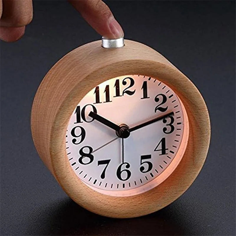 Solid beech wood analogue alarm clock with silent snooze on a wooden bedside table.