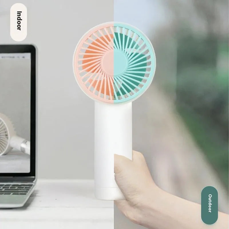 Outdoor portable USB rechargeable handheld fan in pink with three plastic blades and single speed button