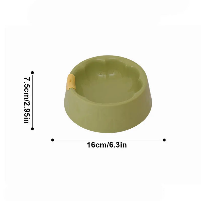 Green plastic pet double bowl with food and water compartments showing anti-tipping design