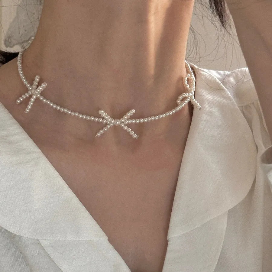White imitation pearl necklace with bow pendant on adjustable 31-40cm chain