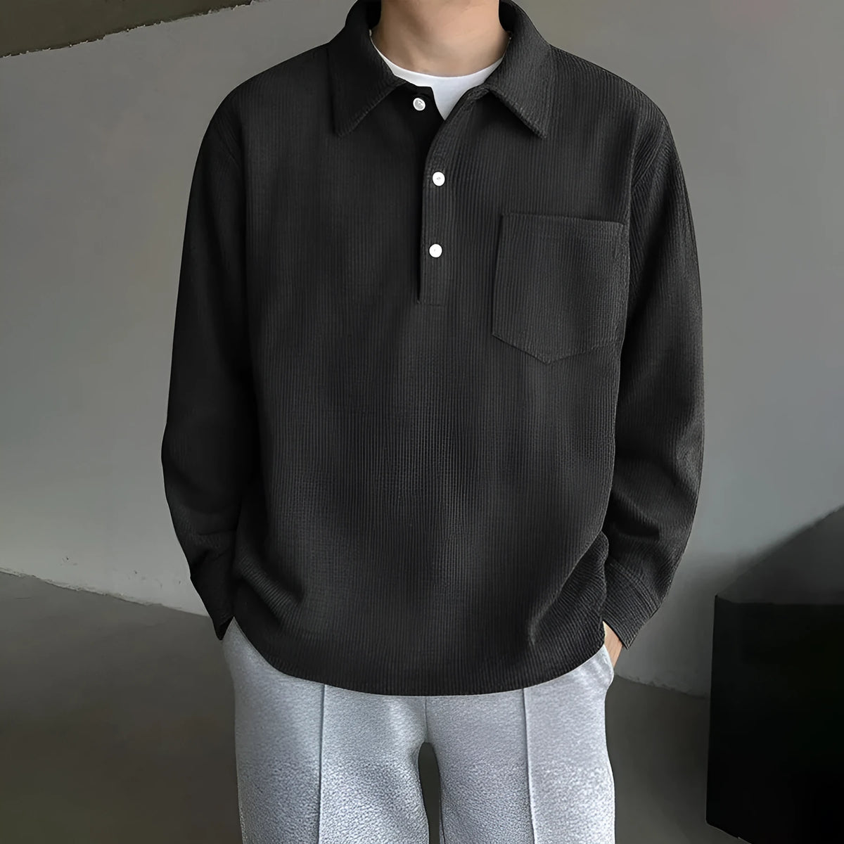 American retro casual bottoming shirt pullover in black, loose fit polyester fibre top on plain background.