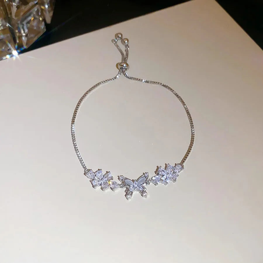 Copper flower butterfly pendant bracelet with inlaid zircon stones gold colour on white background