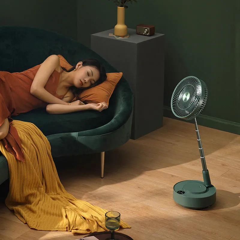 Green telescopic floor-standing electric fan with remote control in extended position