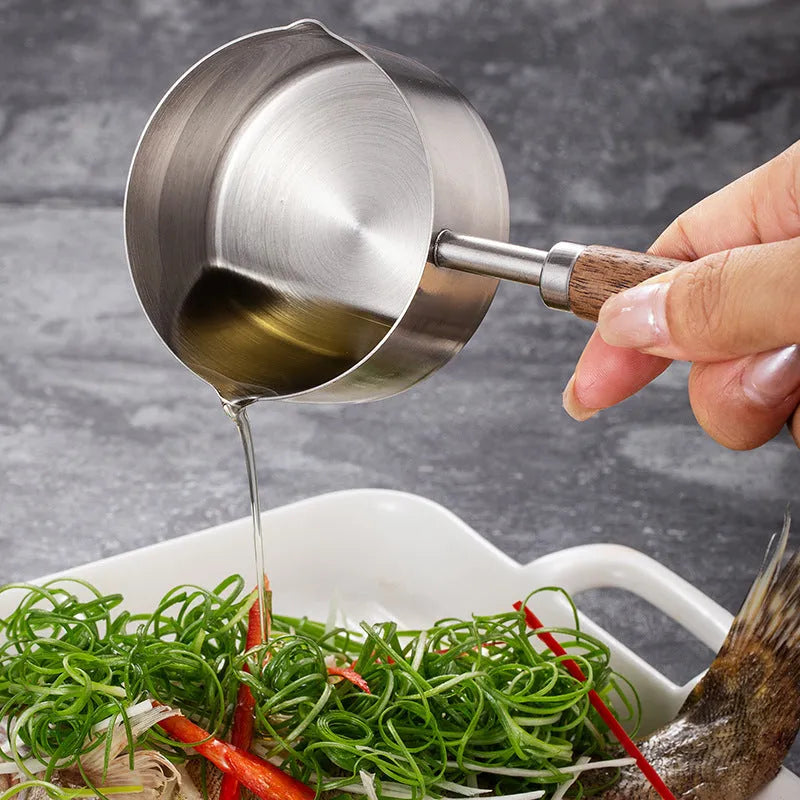Two 304 stainless steel dog food scoops with wooden handles on a surface