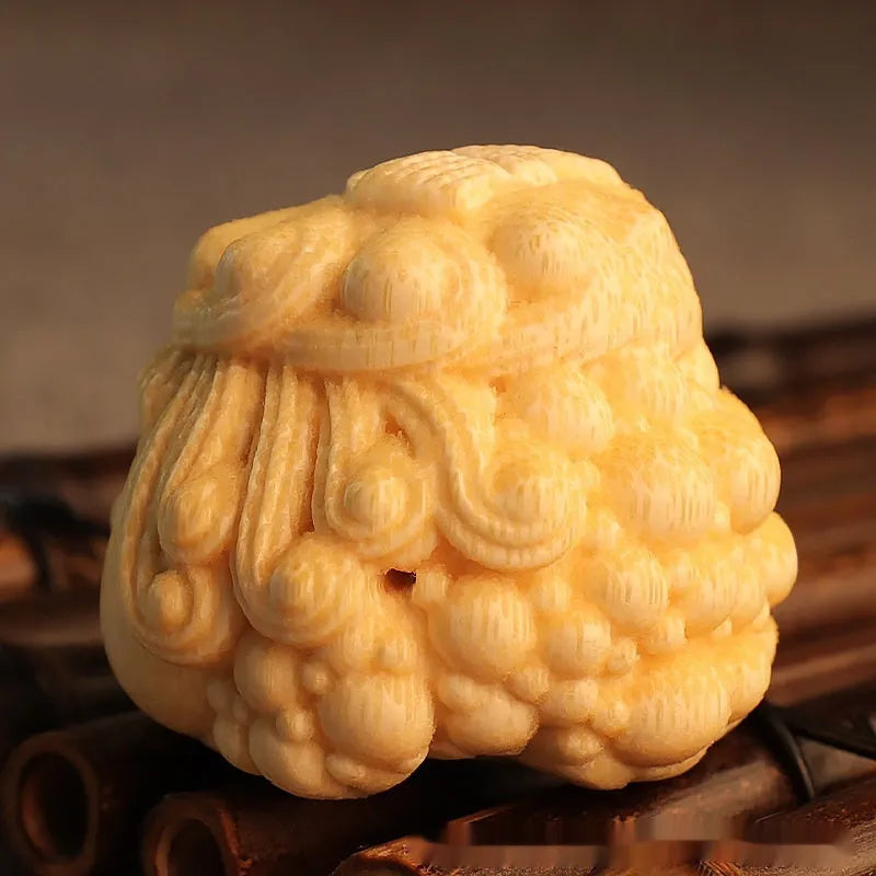 Solid bamboo carving of a cute Golden Toad Princess ornament on a neutral background.