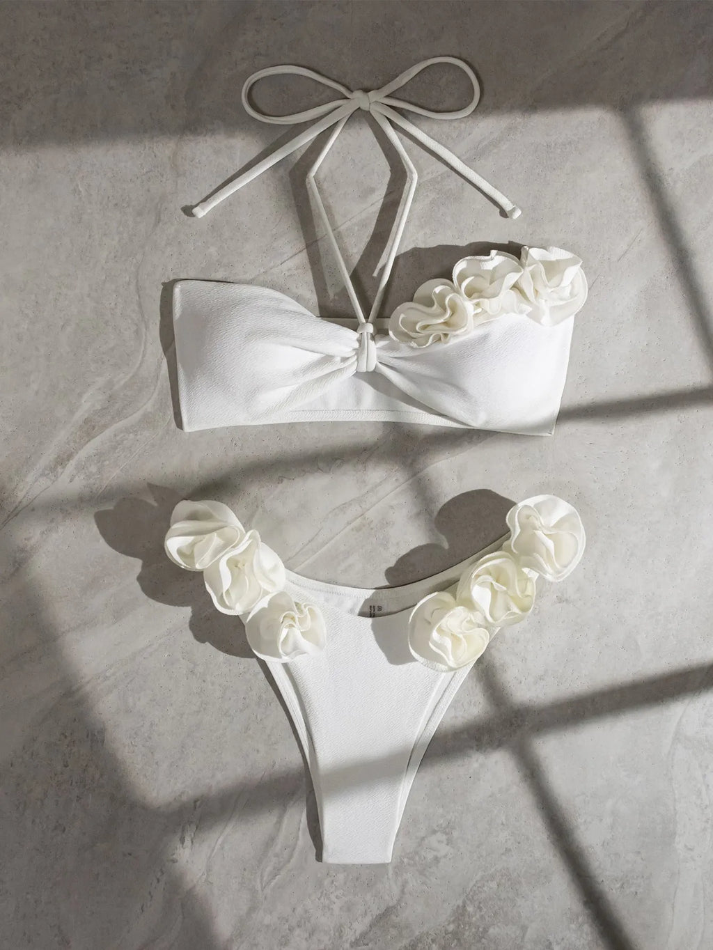 White split swimsuit with three-dimensional flower, halter lace-up neck, and briefs style, sizes S M L
