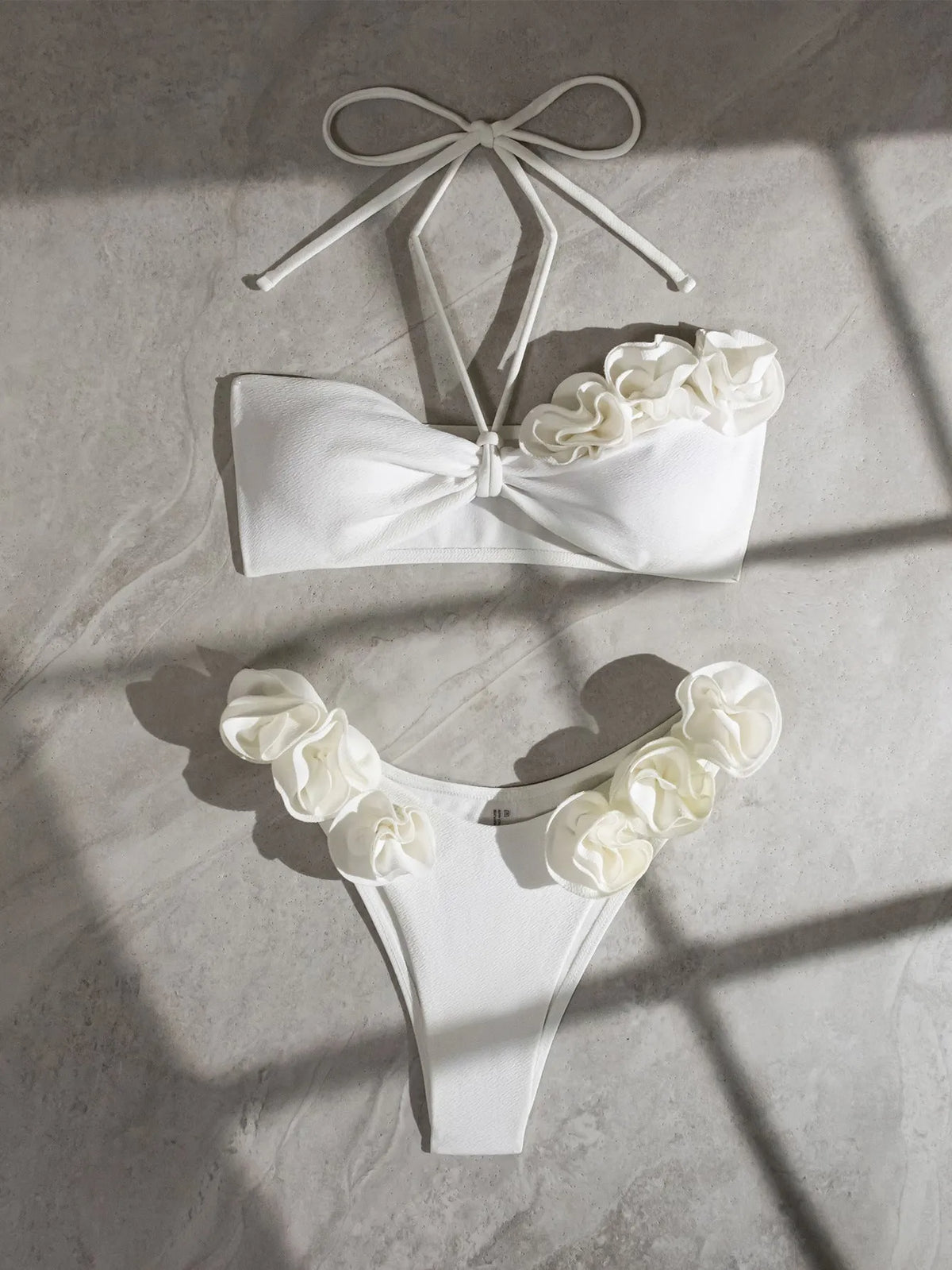 White split swimsuit with three-dimensional flower, halter lace-up neck, and briefs style, sizes S M L